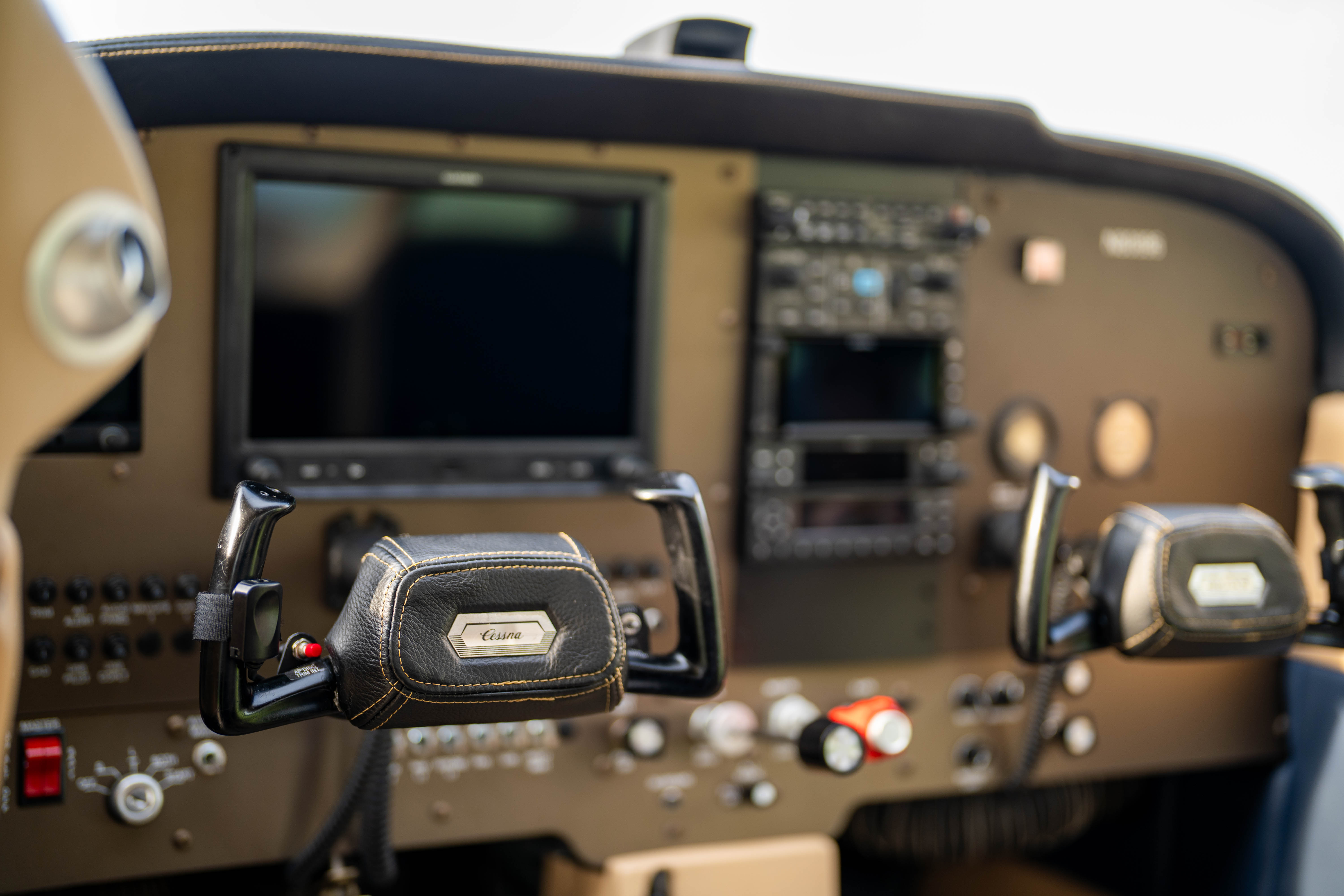 Control yokes and instruments inside a training aircraft cockpit.