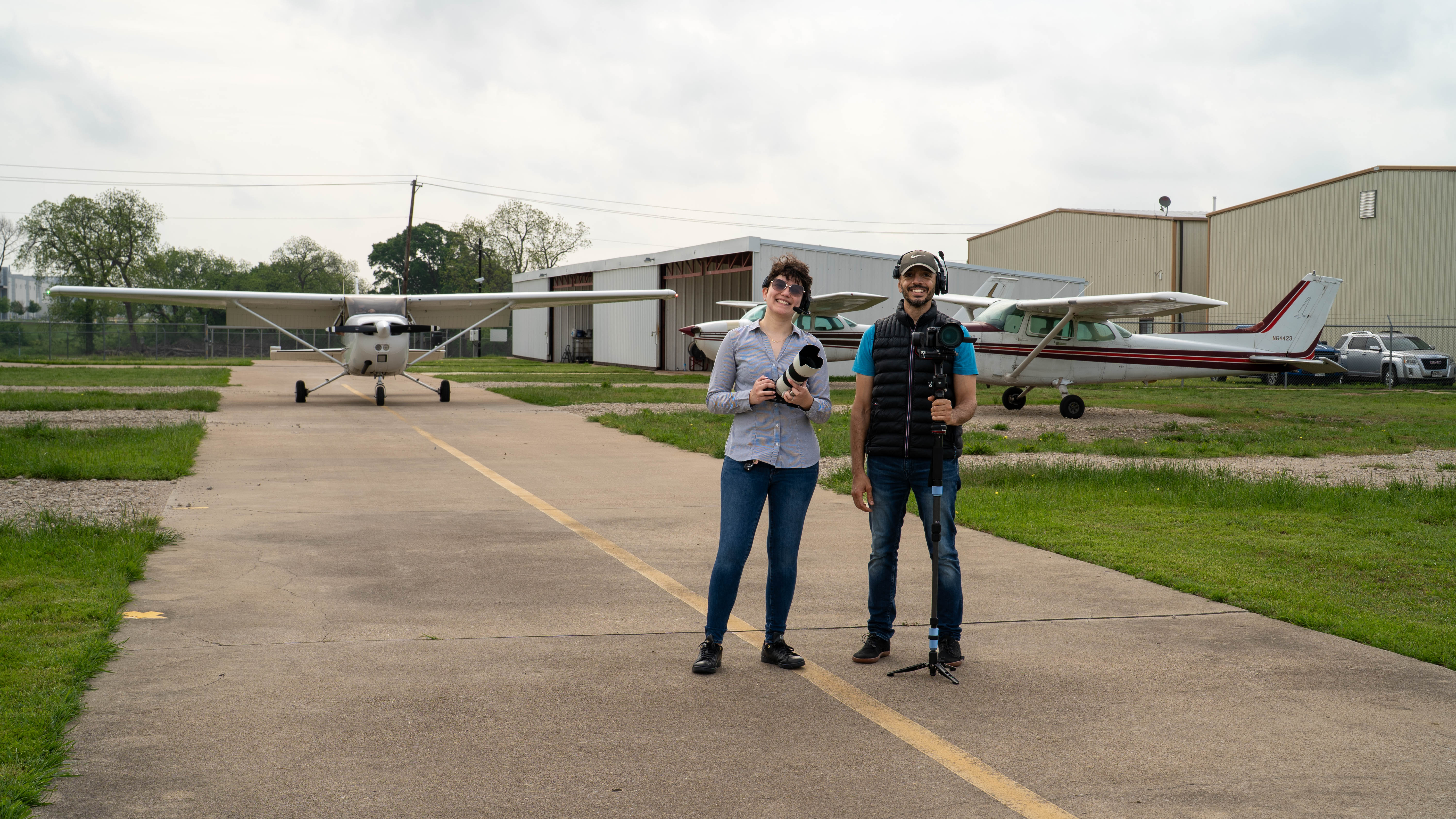 Two people standing together beside aircraft on the apron.
